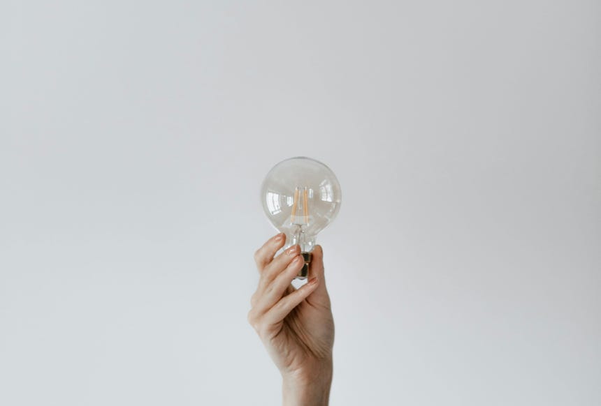 Anonymous female showing light bulb